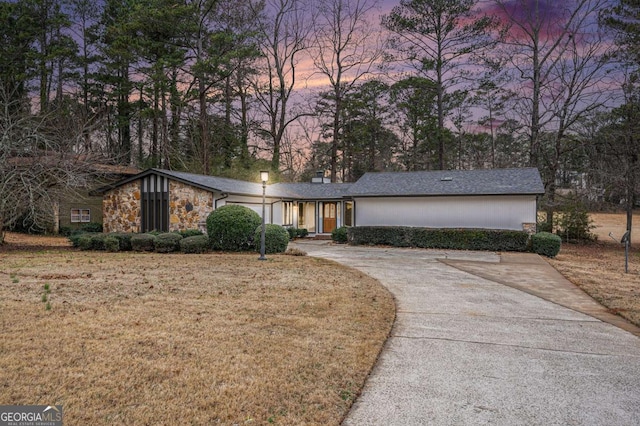 ranch-style home with a yard