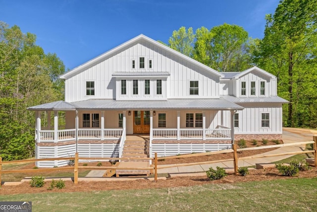 4226 Quail Creek Dr, Flowery Branch, GA 30542 - modern farmhouse style home with board and batten siding, a porch, a metal roof, and a front yard