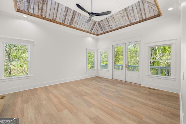 unfurnished sunroom featuring wood ceiling and ceiling fan