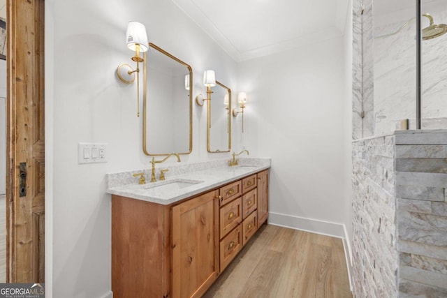 bathroom featuring vanity, hardwood / wood-style flooring, and ornamental molding