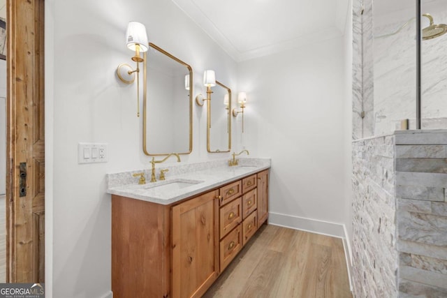 4226 Quail Creek Dr, Flowery Branch, GA 30542 - bathroom with double vanity, wood finished floors, and ornamental molding