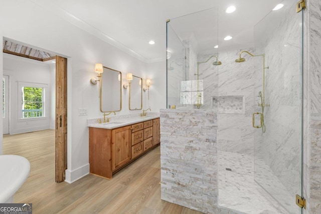 bathroom featuring vanity, hardwood / wood-style flooring, ornamental molding, and separate shower and tub