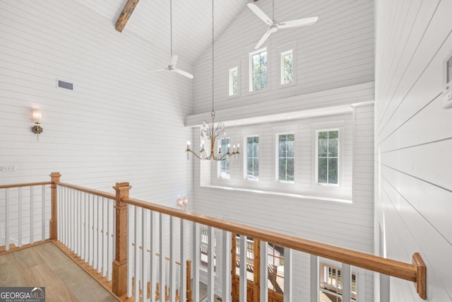 hall featuring a notable chandelier, high vaulted ceiling, and light wood-type flooring