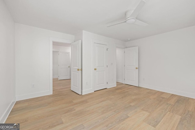 unfurnished bedroom featuring ceiling fan and light wood-type flooring