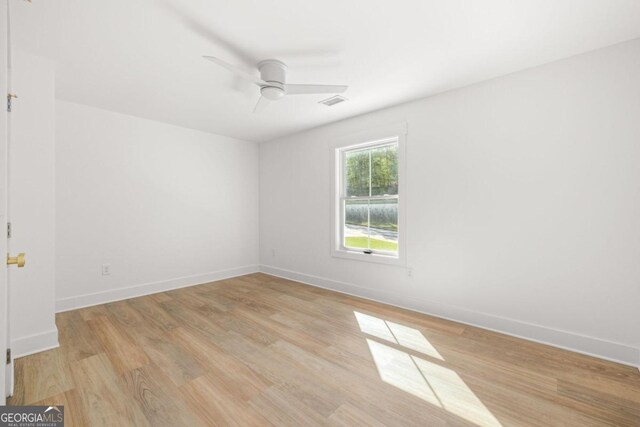 empty room with ceiling fan and light wood-type flooring