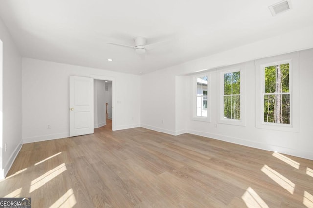 unfurnished room with ceiling fan and light wood-type flooring