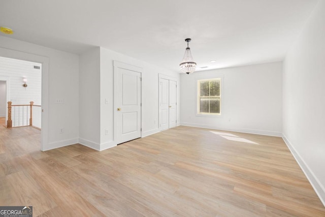 4226 Quail Creek Dr, Flowery Branch, GA 30542 - unfurnished room with light wood-type flooring and a chandelier