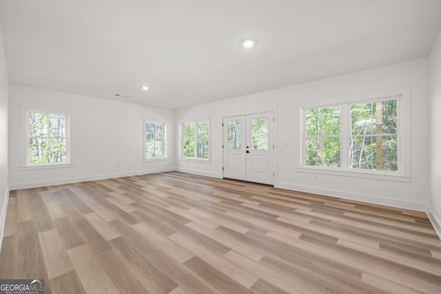 unfurnished living room featuring light wood-type flooring