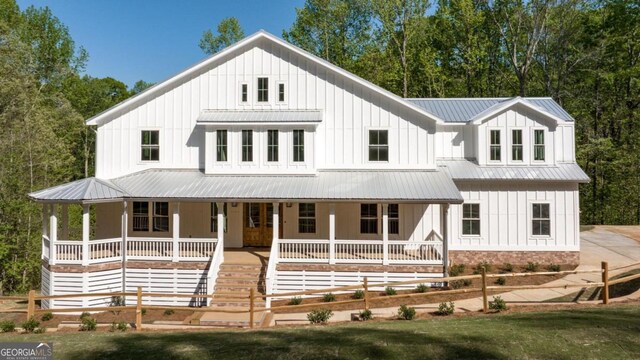 4226 Quail Creek Dr, Flowery Branch, GA 30542 - modern farmhouse featuring board and batten siding, a metal roof, and covered porch