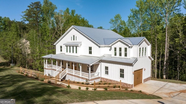4226 Quail Creek Dr, Flowery Branch, GA 30542 - modern inspired farmhouse with covered porch, an attached garage, board and batten siding, driveway, and a metal roof