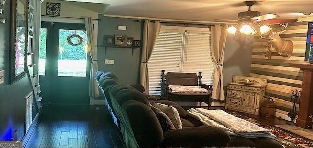 living room with wood-type flooring and ceiling fan