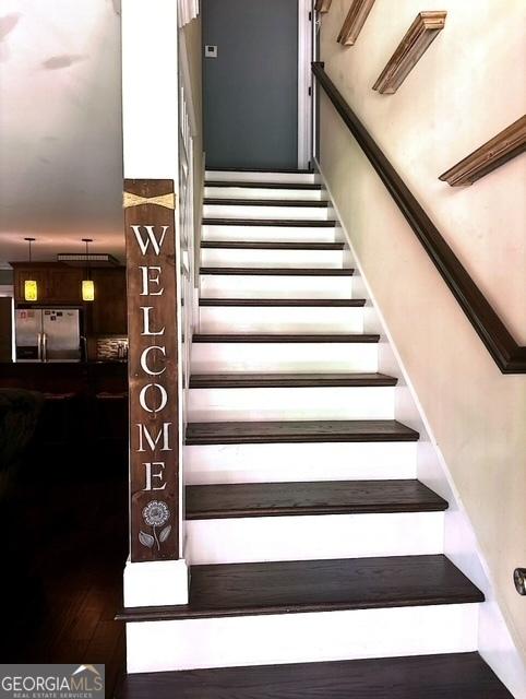 staircase featuring hardwood / wood-style flooring