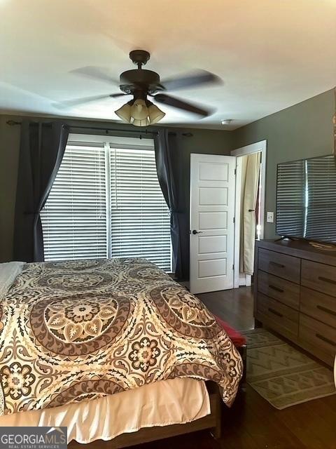 bedroom featuring dark hardwood / wood-style flooring and ceiling fan