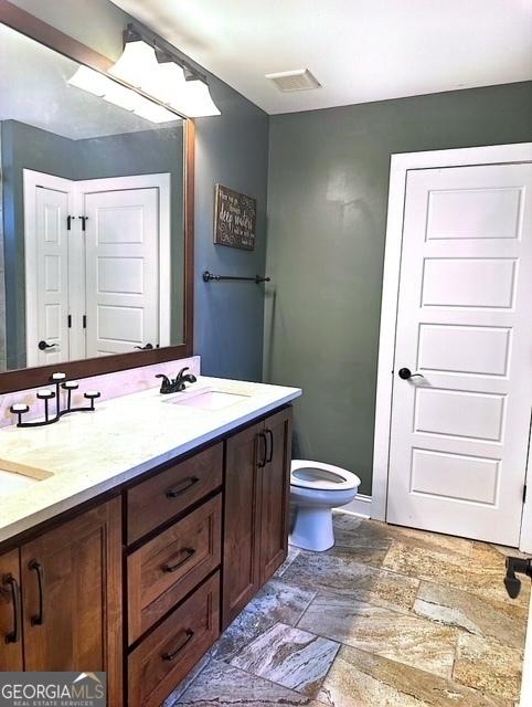 bathroom with vanity and toilet