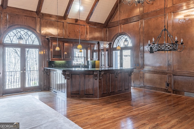 bar featuring a wealth of natural light, decorative light fixtures, dark wood-type flooring, beam ceiling, and french doors