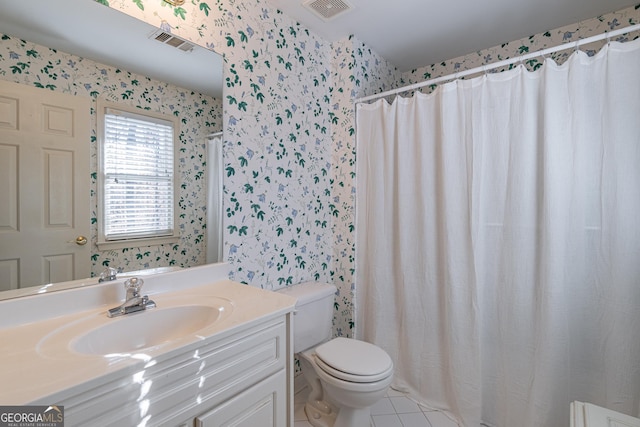 bathroom featuring tile patterned flooring, vanity, and toilet