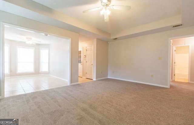 carpeted spare room with ceiling fan