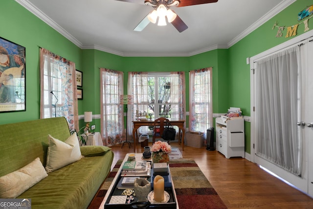 living room with crown molding, dark hardwood / wood-style floors, and ceiling fan