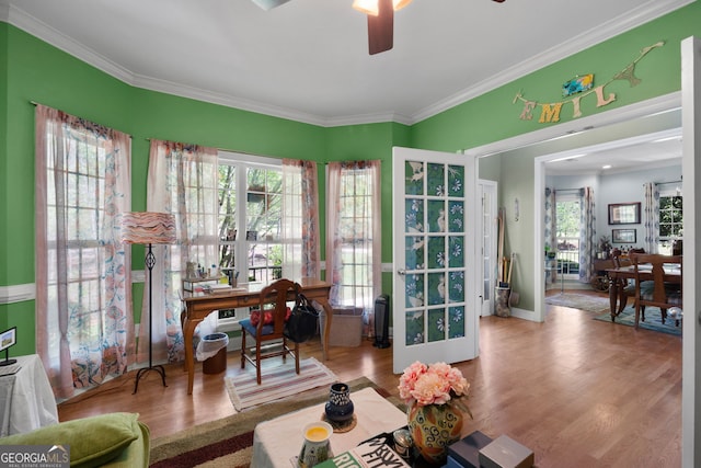 interior space featuring hardwood / wood-style flooring, crown molding, and ceiling fan