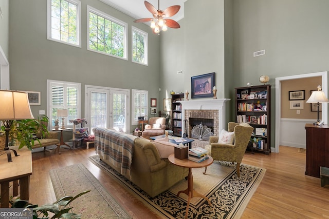 living room featuring a wealth of natural light, a fireplace, and light wood-type flooring