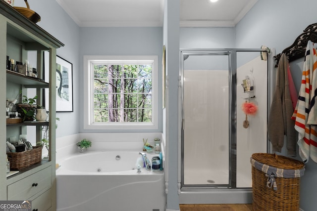 bathroom with ornamental molding and independent shower and bath