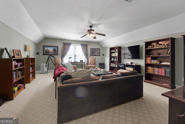 living room with ceiling fan, light colored carpet, and lofted ceiling