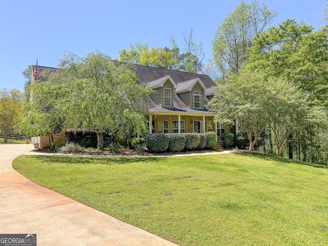 cape cod house with a porch and a front lawn