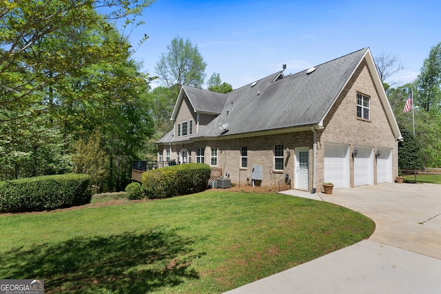 view of front of house with central AC unit, a garage, and a front yard