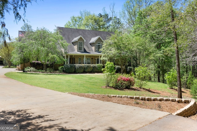 cape cod house with a front lawn