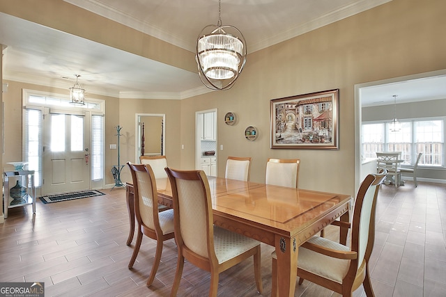 dining room featuring crown molding, a chandelier, and light hardwood / wood-style floors