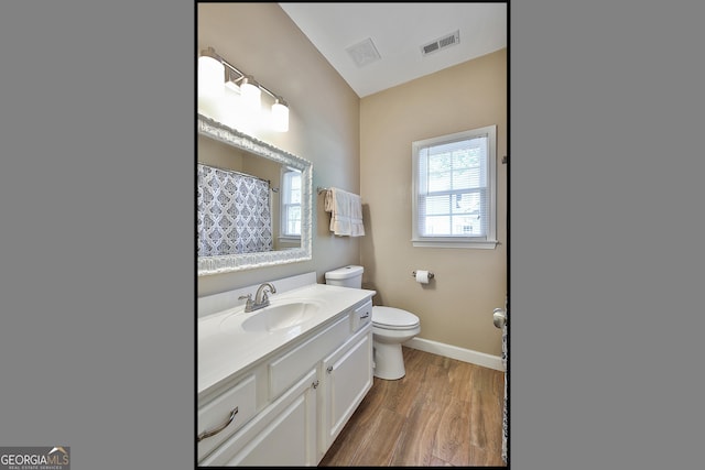 bathroom with vanity, hardwood / wood-style floors, a shower with curtain, and toilet