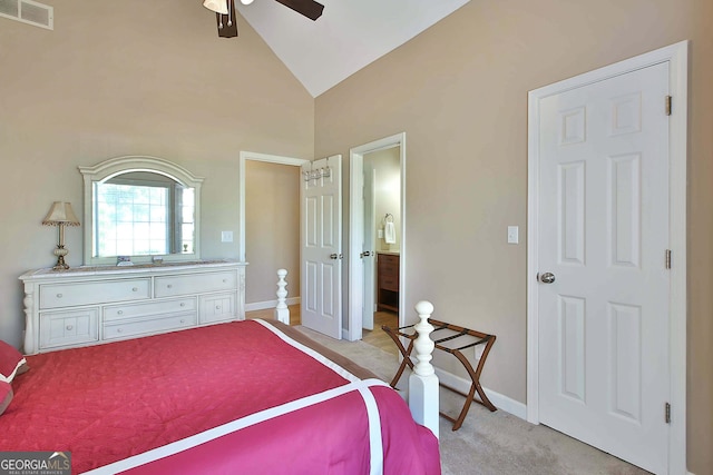 bedroom featuring light carpet, ensuite bath, high vaulted ceiling, and ceiling fan