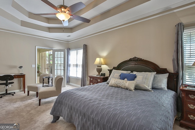 bedroom with crown molding, access to outside, ceiling fan, a tray ceiling, and light colored carpet