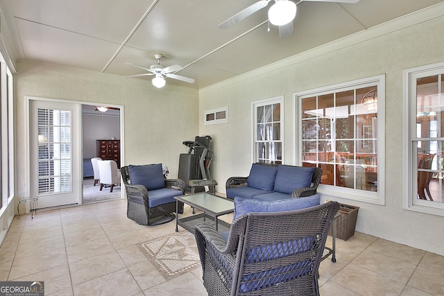 sunroom featuring ceiling fan