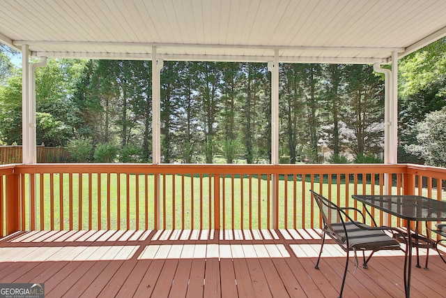 wooden deck featuring a yard