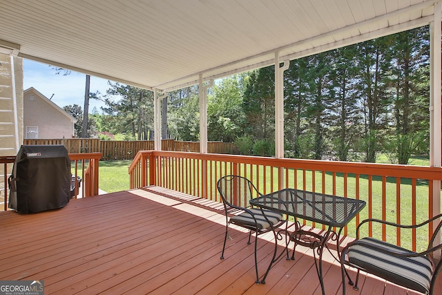 deck featuring area for grilling and a yard