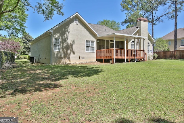 rear view of house featuring central AC unit, a yard, and a deck