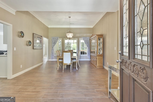 dining room featuring ornamental molding and hardwood / wood-style floors