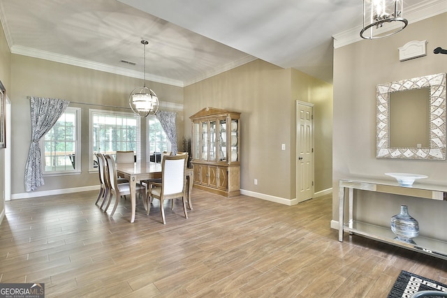 dining area with ornamental molding and hardwood / wood-style floors