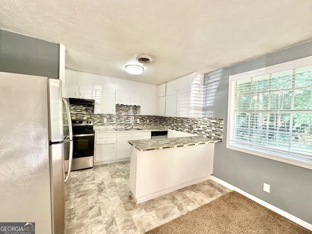 kitchen with white cabinetry, sink, decorative backsplash, stainless steel appliances, and a textured ceiling