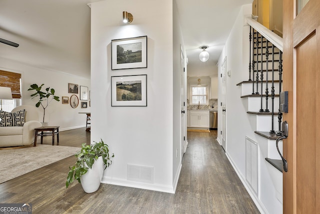 corridor featuring dark hardwood / wood-style floors and sink