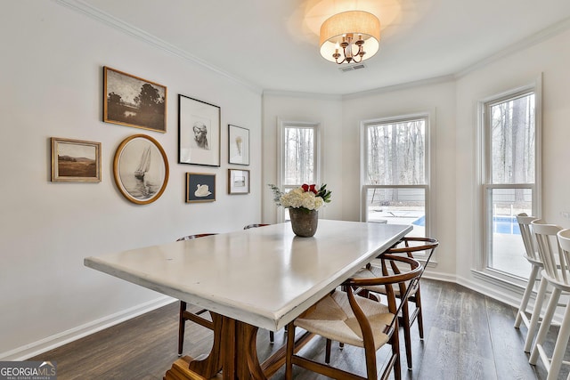 dining room featuring dark hardwood / wood-style flooring and ornamental molding