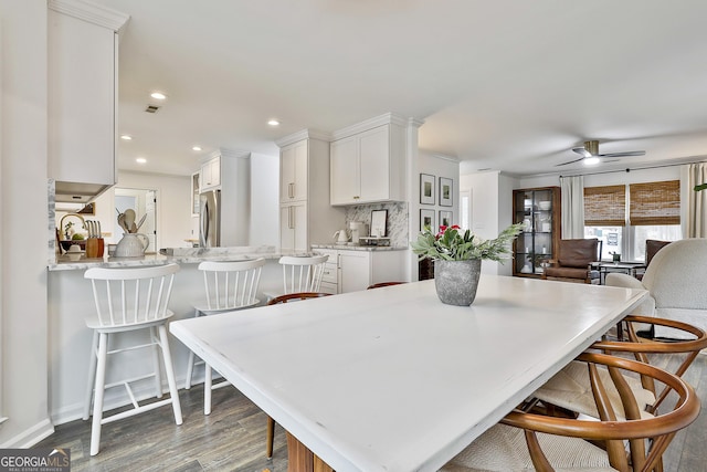 dining area with hardwood / wood-style flooring and ceiling fan