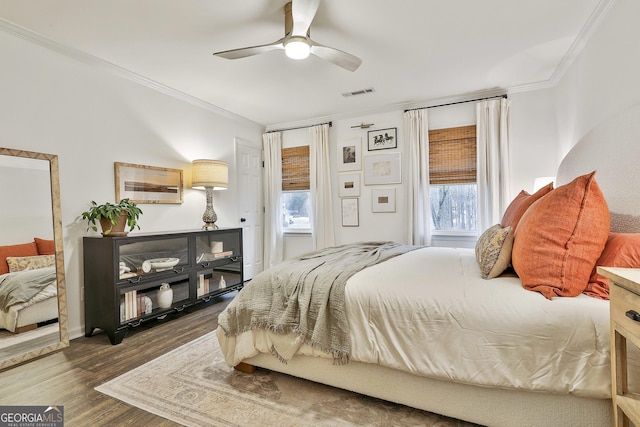 bedroom featuring crown molding, ceiling fan, and dark wood-type flooring