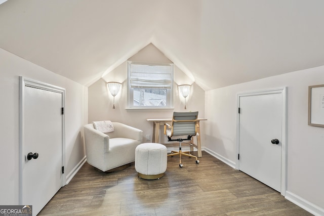 living area with vaulted ceiling and hardwood / wood-style floors