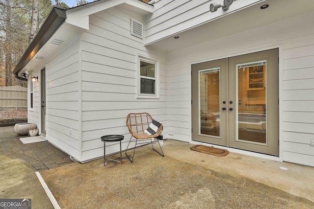 property entrance with a patio area and french doors