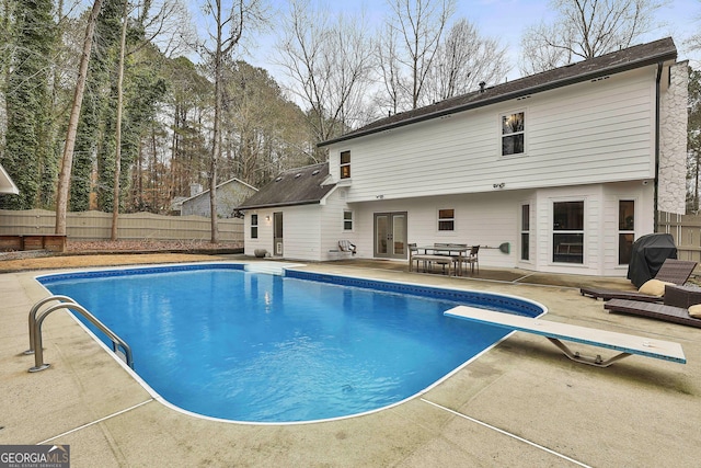 view of pool featuring a patio and a diving board