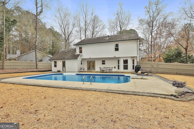 back of house with a fenced in pool and a patio area