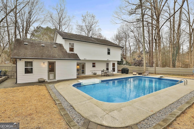 view of pool featuring a diving board and a patio area