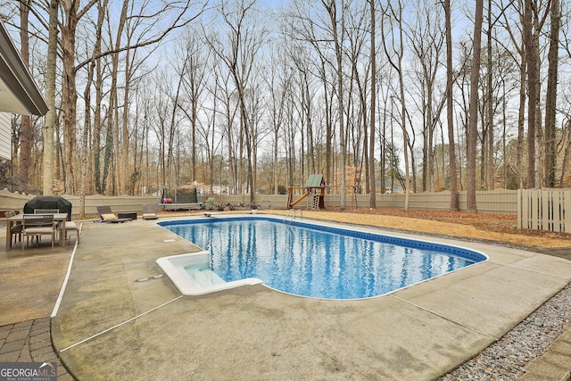 view of pool featuring area for grilling, a playground, a patio area, and a trampoline